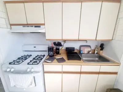 a kitchen with a stove and a sink at Cozy & Inviting A Place to Call Home in Melrose Park
