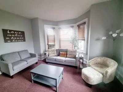 a living room with two couches and a coffee table at Cozy & Inviting A Place to Call Home in Melrose Park