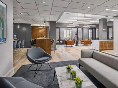 an office lobby with a couch and a chair at The Franklin Residences - Extended Stay Furnished Apartment, Philadelphia PA in Philadelphia