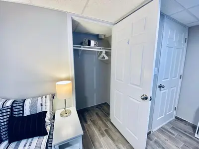 a small bedroom with a bed and a closet at Bright, Stylish and Comfy Luxury Room With Workspace! in Haledon