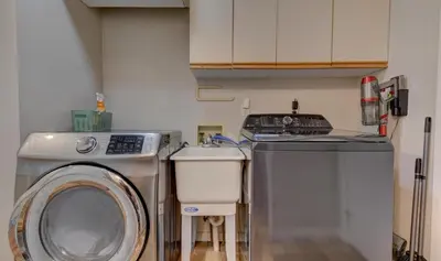 a kitchen with a washing machine and a sink at Hot tub, Sauna, fire pit, games and nature in Lake Poconos in Pocono Summit