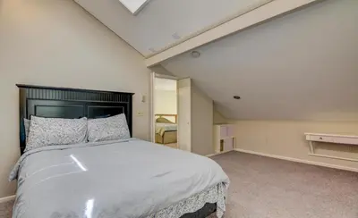 a bedroom with a large bed with a black headboard at Hot tub, Sauna, fire pit, games and nature in Lake Poconos in Pocono Summit