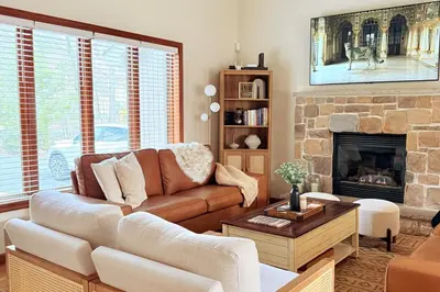 a living room with a couch and a fireplace at Modern Home - Privacy - Prime Location - 18min Camelback Ski Resort in Tobyhanna