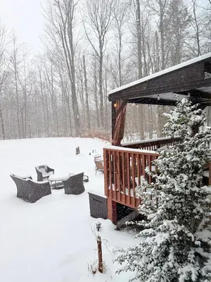 a cabin in the snow with a snow covered tree at Modern Home - Privacy - Prime Location - 18min Camelback Ski Resort in Tobyhanna