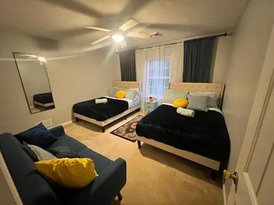 a living room with two beds and a couch at Golden Deer Lodge in Tobyhanna
