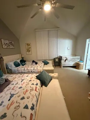 a bedroom with two beds and a ceiling fan at Golden Deer Lodge in Tobyhanna