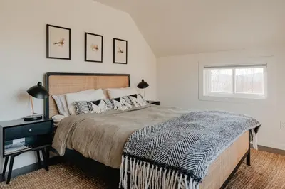 a bedroom with a large bed and a window at Luxe Gabel Farmhouse Fire Pit & Country Views in Callicoon