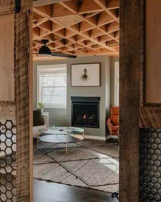 a living room with a table and a fireplace at Luxe Gabel Farmhouse Fire Pit & Country Views in Callicoon