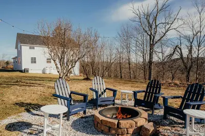 three chairs and a fire pit in a yard at Luxe Gabel Farmhouse Fire Pit & Country Views in Callicoon