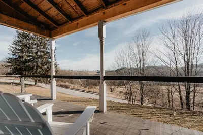 a screened porch with chairs and a view of a road at Luxe Gabel Farmhouse Fire Pit & Country Views in Callicoon