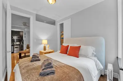 a bedroom with a large bed with shoes on it at Modern 2BR with Private Garden - In Gramercy Park in New York
