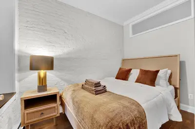a bedroom with a bed and a lamp on a nightstand at Gramercy Apartment - 3BR 2BA Modern Central in New York
