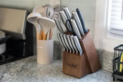 a knife block filled with utensils on a counter at Spacious Apartment - 3 min Train to NYC in Bayonne
