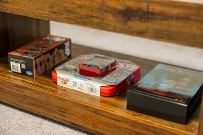 a group of boxes on a wooden shelf at Spacious Apartment - 3 min Train to NYC in Bayonne