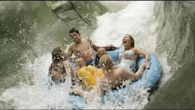 a group of people on a raft in a waterfall at Cozy Studio Resort Stay Mountain Creek Pool Hiking in Vernon Township