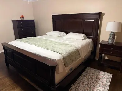 a bedroom with a large bed and a dresser at NY City View West Orange Villa 5 bedroom in West Orange