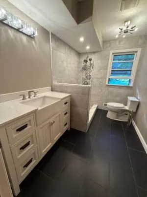 a bathroom with a sink and a toilet and a window at NY City View West Orange Villa 5 bedroom in West Orange