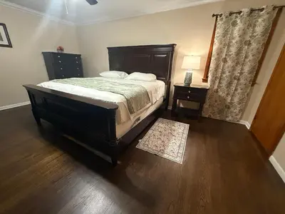 a bedroom with a bed and a dresser and a lamp at NY City View West Orange Villa 5 bedroom in West Orange