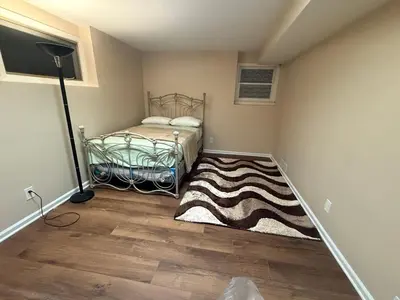 a small bedroom with a bed and a rug at NY City View West Orange Villa 5 bedroom in West Orange