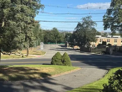 an empty street with two trees on the side of the road at NY City View West Orange Villa 5 bedroom in West Orange