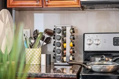 a kitchen with a counter top with a stove with a counter top at New Modern Apt in Chinatown Parking Available in Philadelphia