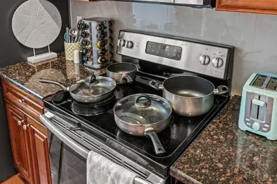 a kitchen with pots and pans on a stove at New Modern Apt in Chinatown Parking Available in Philadelphia