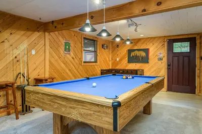 a pool table in a room with wooden walls at Lake Harmony Getaway in Lake Harmony