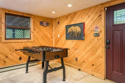 a ping pong table in a room with a wooden wall at Lake Harmony Getaway in Lake Harmony