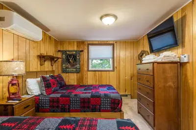 a bedroom with a bed and a dresser at Lake Harmony Getaway in Lake Harmony