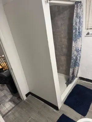 a bathroom with a shower with a glass door at Private Basement near NYC and NJ attractions in East Orange