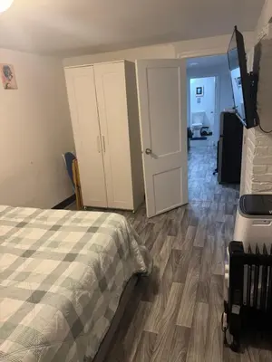 a bedroom with a bed and a door to a room at Private Basement near NYC and NJ attractions in East Orange