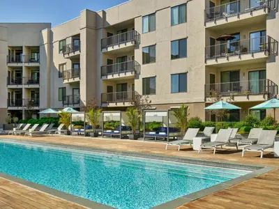 a swimming pool in front of a building at AVE Clifton - Furnished Apartment, Clifton NJ in Clifton
