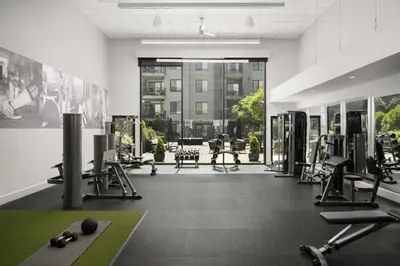 a gym with several treadmills and exercise equipment in a building at AVE Clifton - Furnished Apartment, Clifton NJ in Clifton