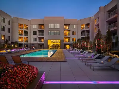 a hotel courtyard with a pool and chairs and buildings at AVE Clifton - Furnished Apartment, Clifton NJ in Clifton