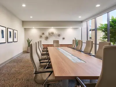 a conference room with a wooden table and chairs at AVE Clifton - Furnished Apartment, Clifton NJ in Clifton