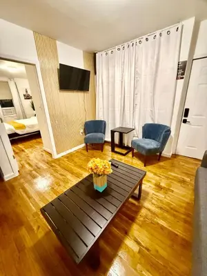a living room with a coffee table and two chairs at NYCRiverside 2BR Apt 20MintsTime Square in West New York