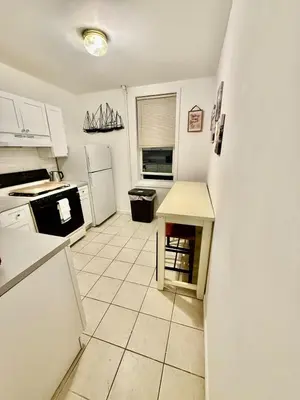a kitchen with white appliances and a tile floor at NYCRiverside 2BR Apt 20MintsTime Square in West New York
