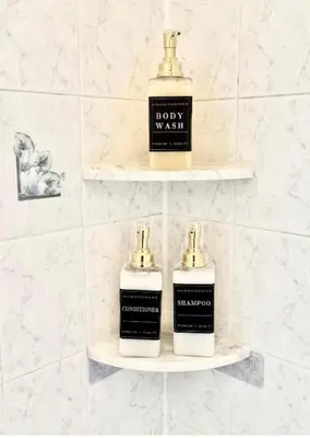 two bottles of soap sitting on shelves in a bathroom at NYCRiverside 2BR Apt 20MintsTime Square in West New York