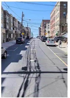 an empty city street with cars parked on the road at NYCRiverside 2BR Apt 20MintsTime Square in West New York