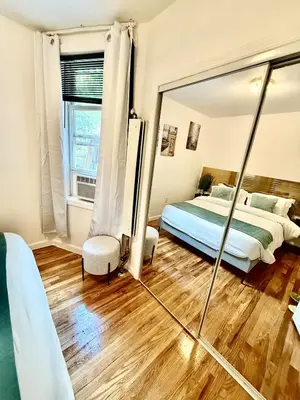 a bedroom with a bed and a mirror at NYCRiverside 2BR Apt 20MintsTime Square in West New York