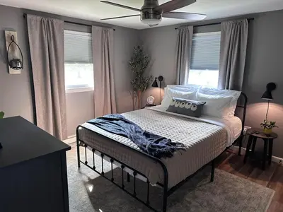 a bedroom with a bed and a ceiling fan at Walnut Street Retreat with Hot Tub, 3 Bedrooms in Ephrata