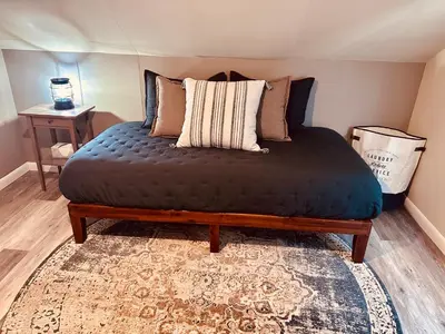 a large bed in a room with a rug at Walnut Street Retreat with Hot Tub, 3 Bedrooms in Ephrata