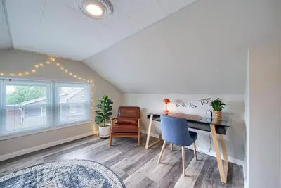 a room with a desk and chairs and a window at Walnut Street Retreat with Hot Tub, 3 Bedrooms in Ephrata