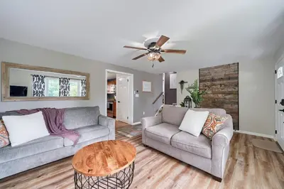 a living room with two couches and a table at Walnut Street Retreat with Hot Tub, 3 Bedrooms in Ephrata