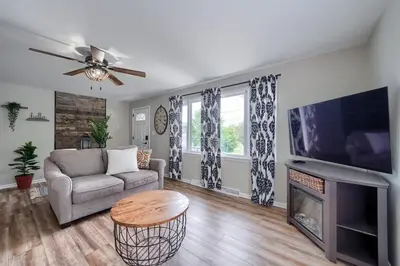 a living room with a couch and a tv at Walnut Street Retreat with Hot Tub, 3 Bedrooms in Ephrata