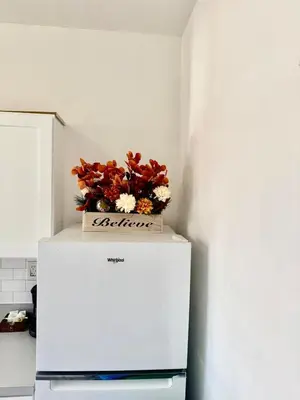 a box of flowers on top of a refrigerator at RiverEdge Apt Gateway20Mints FromTime SquareNYC in West New York