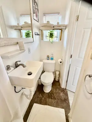 a small bathroom with a toilet and a sink at RiverEdge Apt Gateway20Mints FromTime SquareNYC in West New York