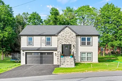 a house with a garage on a street at The Respite getaway in Harrisburg