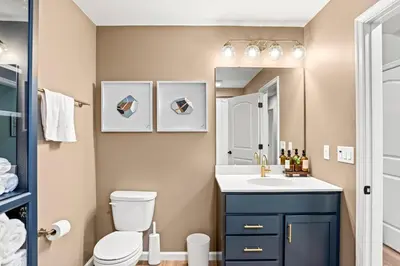 a bathroom with a toilet and a sink and a mirror at The Respite getaway in Harrisburg