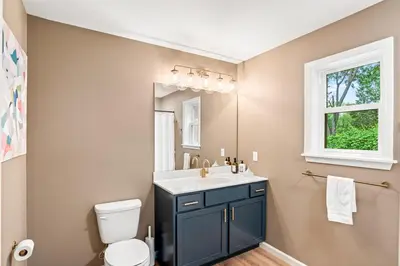 a bathroom with a sink and a toilet and a mirror at The Respite getaway in Harrisburg